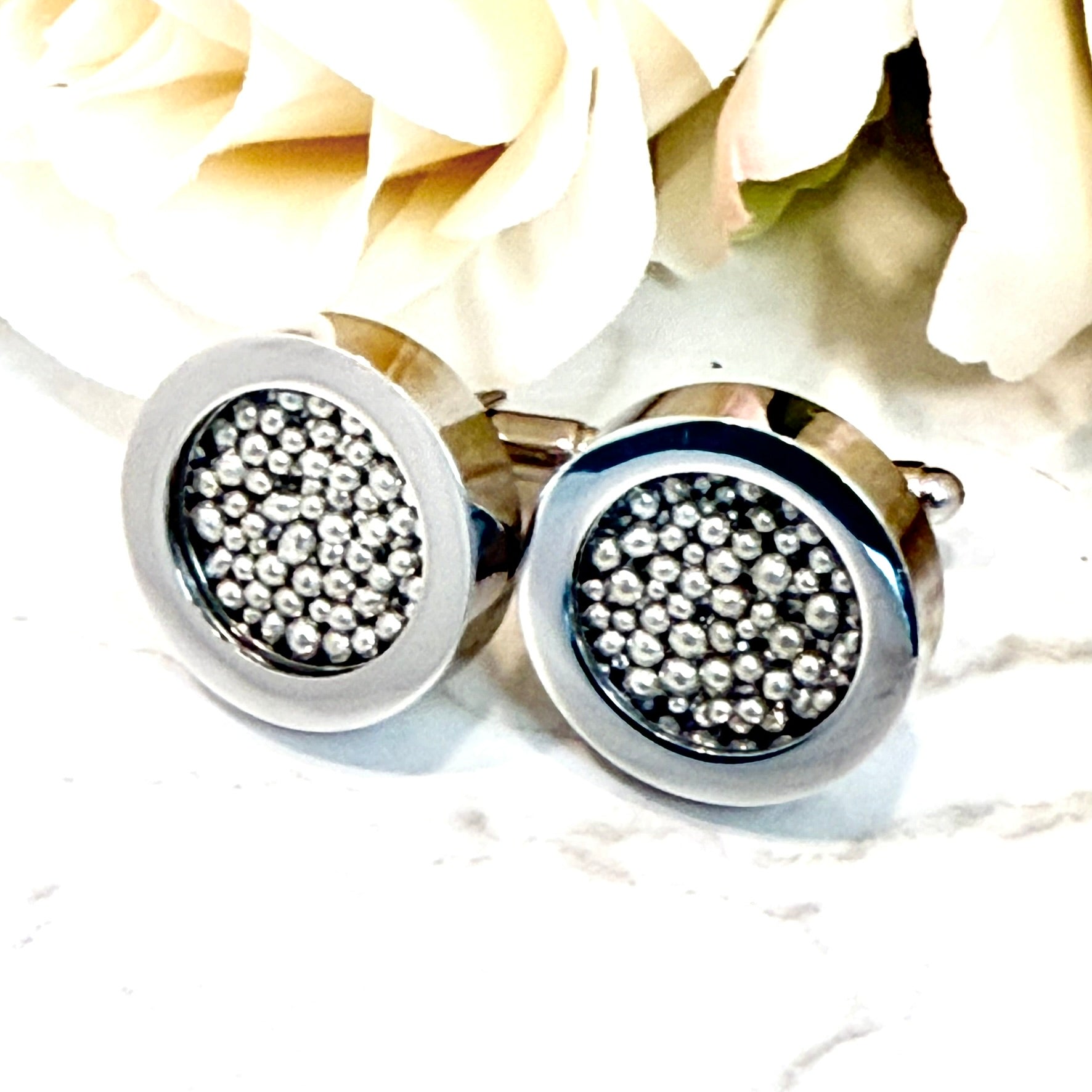 front top view of chunky cufflinks filled with balls of pure tin