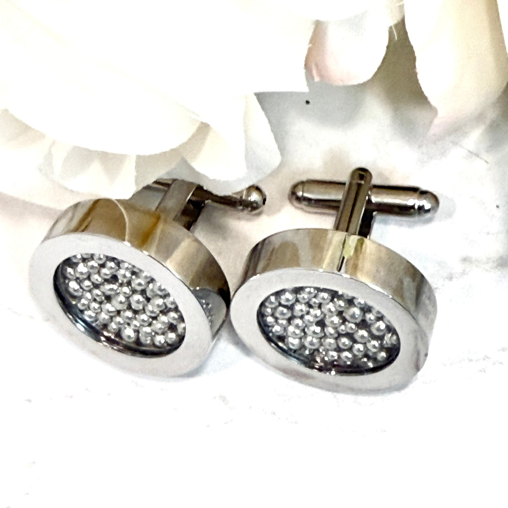 top view of cufflinks filled with pure tine balls and showing bullet back