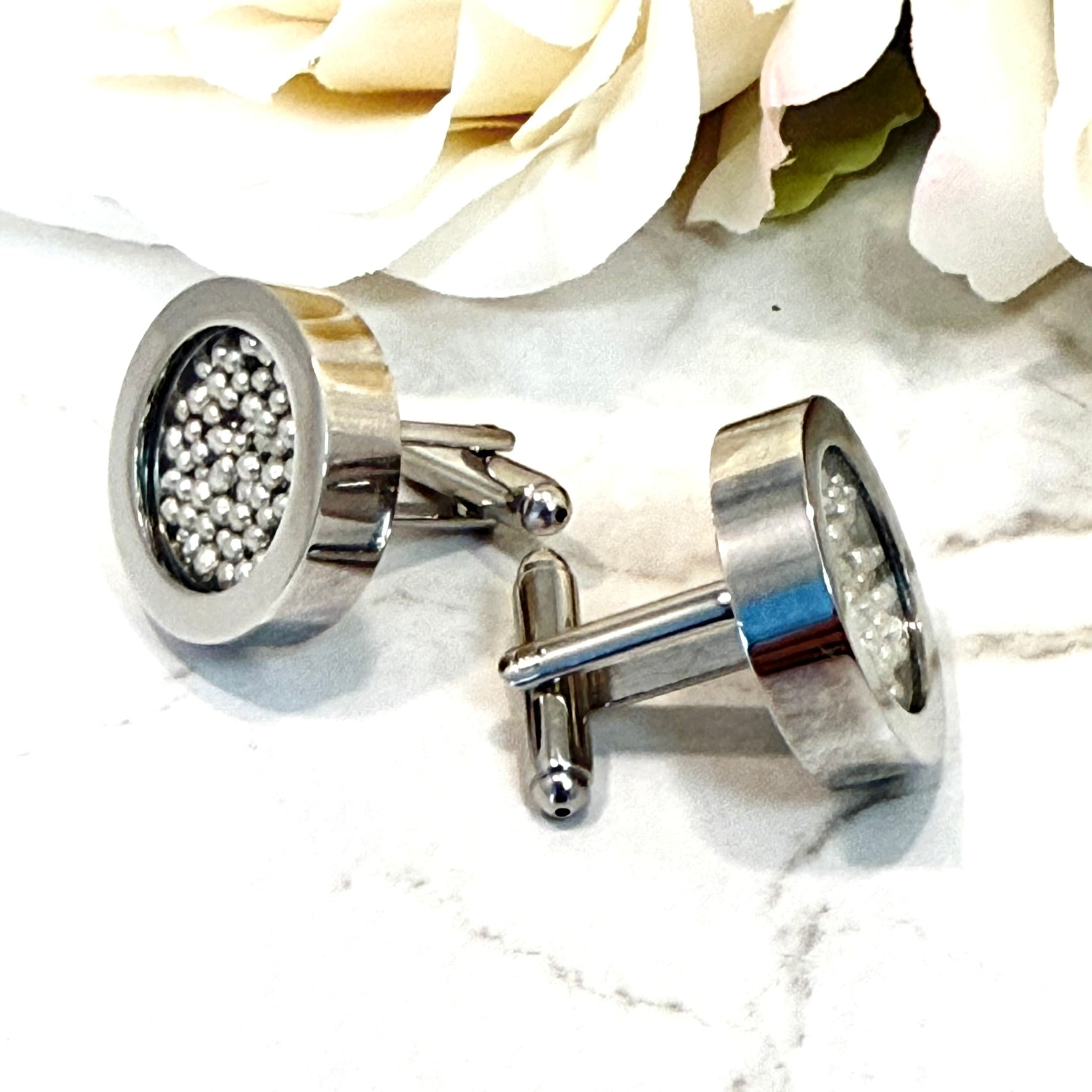 pair of cufflinks filled with our tin balls from two different angles